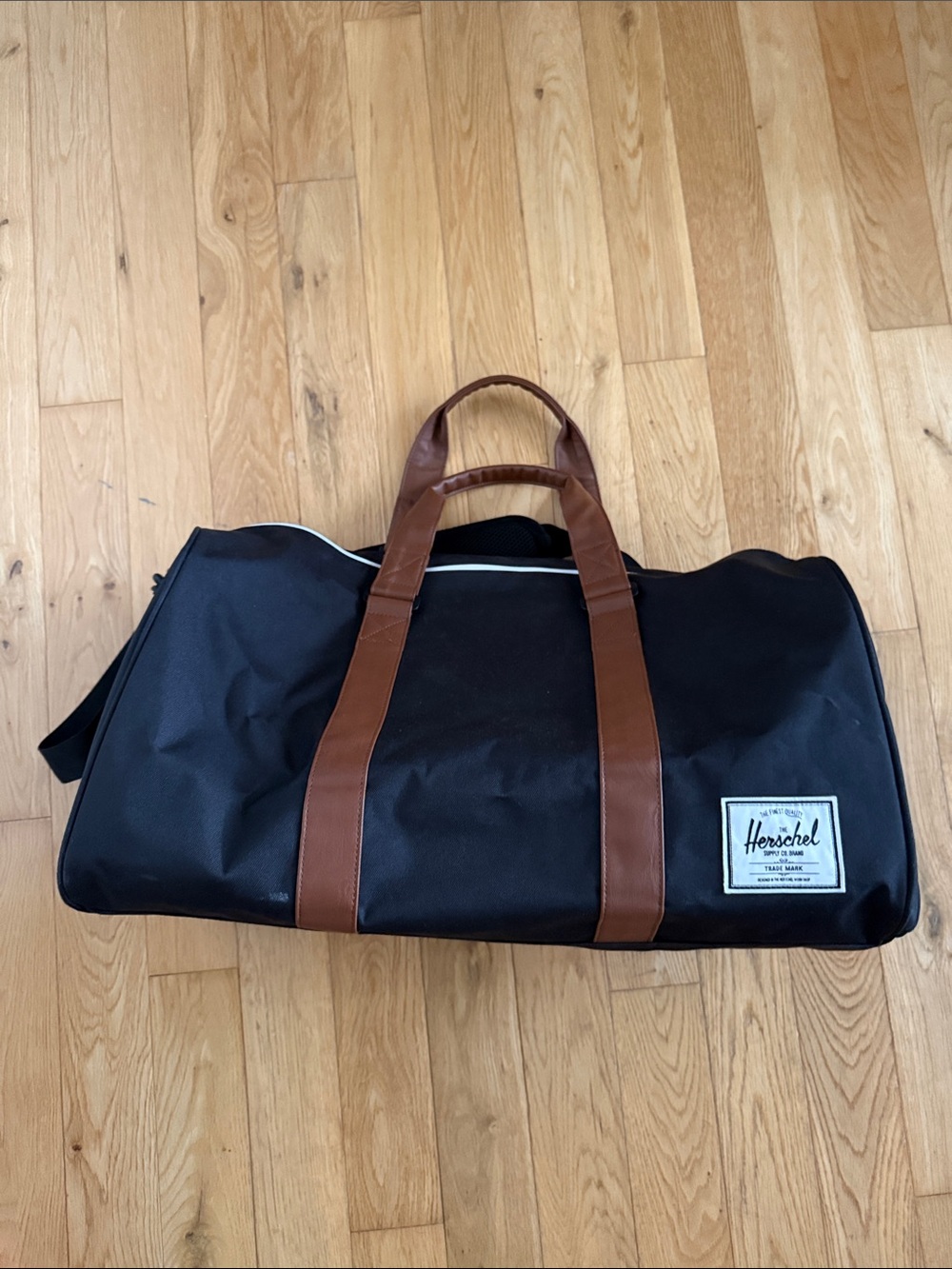 Herschel Supply Company Black Duffel with Brown Straps and White Piping. 43L.